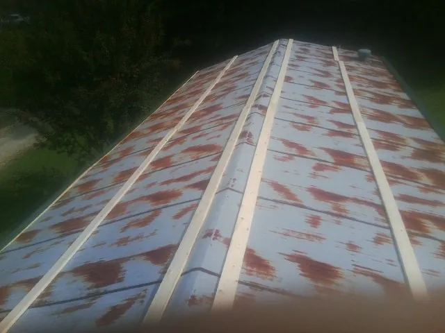Rusted metal roof panels with new wood purlins before replacement — Storm Damage Roof Repair in Flagtown by Roofing Brothers